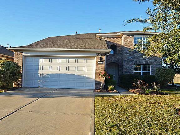  Large live oaks decorate the property, and recent mulch has been added to the landscaping