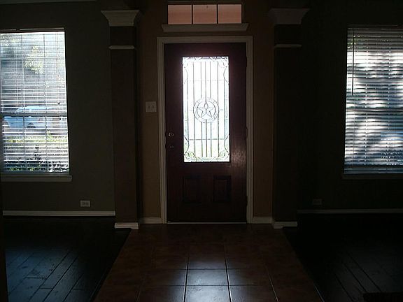 Wood front door with lead glass panel.