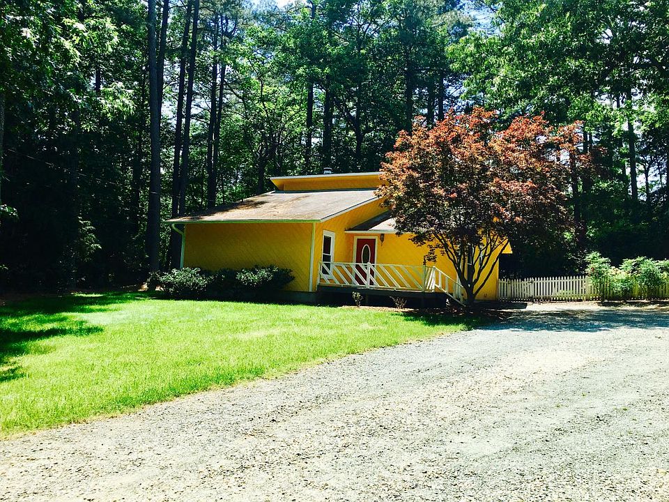 Yellow house with beautiful , mature landscape