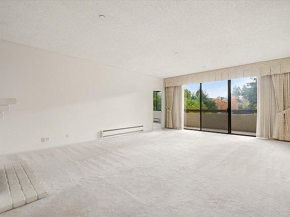 Living room with patio that looks onto the garden and pool