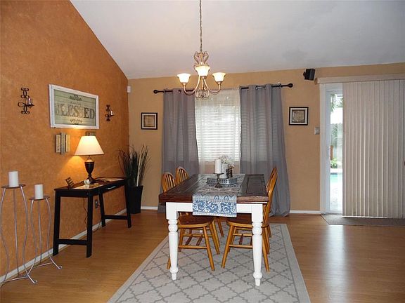 Here is a snapshot of the dinning room / living room/ sun room with laminate wood flooring, nice lighting and the accent wall.