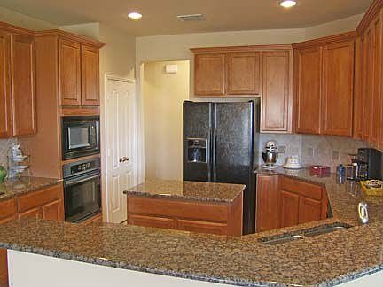 Kitchen has Granite Counters, Stainless Appliances, Maple Cabinets.