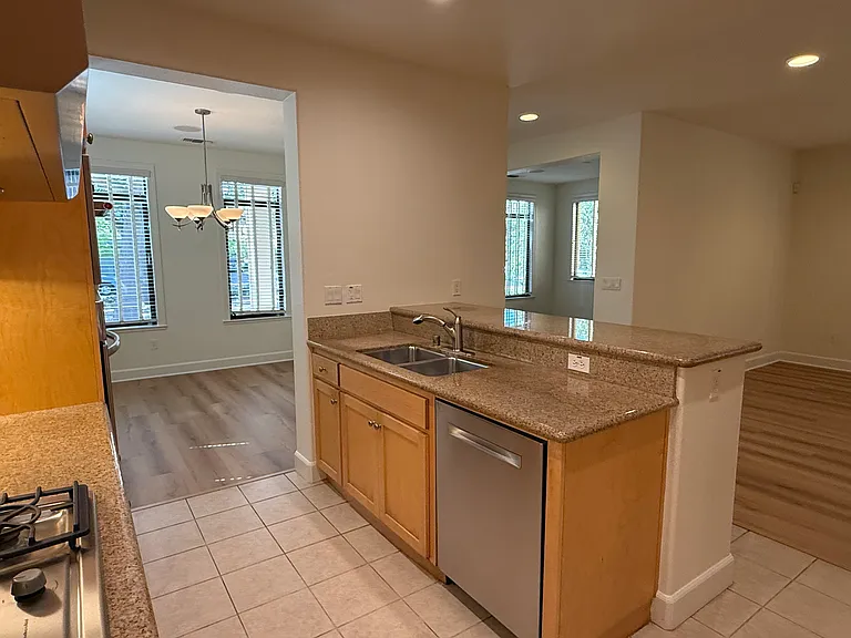 Gourmet kitchen is equipped with stainless steel appliances and soft-close cabinetry and granite countertop with a breakfast bar.