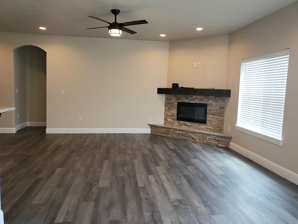 Newer home with ceiling fans throughout. Electric fireplace for cozy effect. Windows to the back yard for privacy.