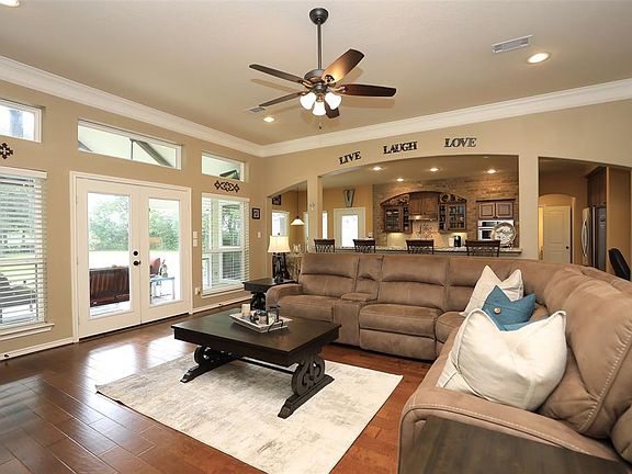 Beautiful family room with hardwood floors and picture windows plus french doors leading to covered patio and outdoor kitchen!