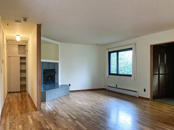 Living Room area as seen from dining room area. Hallway is to the bathroom and two bedrooms. Linen closet at end of hallway.