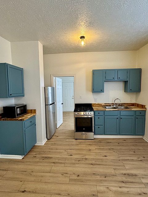 Kitchen with Stainless Steel Appliances: Gas Stove, Microwave, Refrigerator