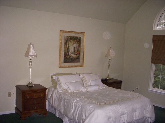 Master bedroom with natural light, ceiling fans and waterviews.