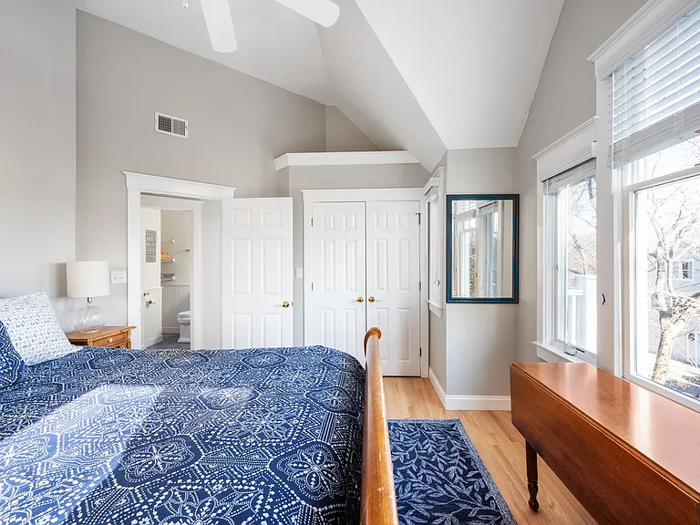 Right front master bedroom with queen bed, ocean views, vaulted ceiling, ceiling fan, large closet, and door to screened porch.