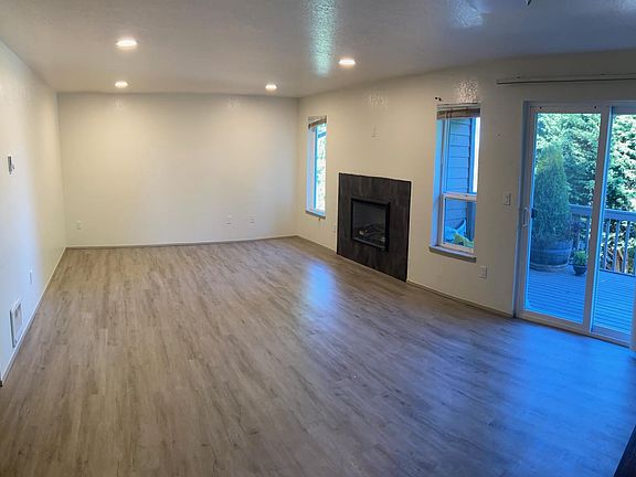Living room with electric fireplace and deck.