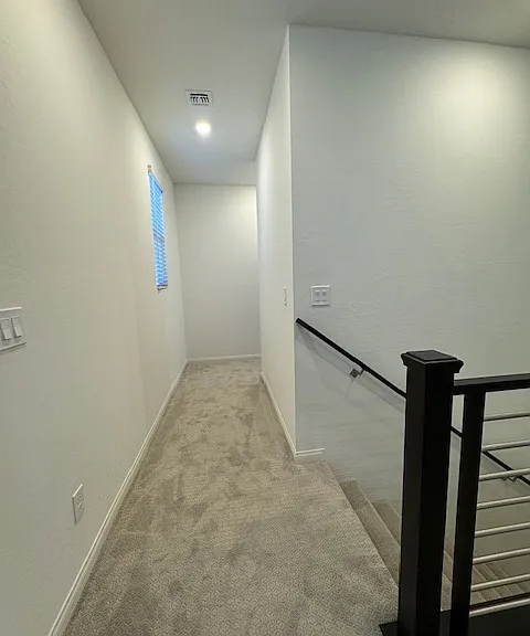 hallway back to the 3 additional bedrooms and 2nd full bath