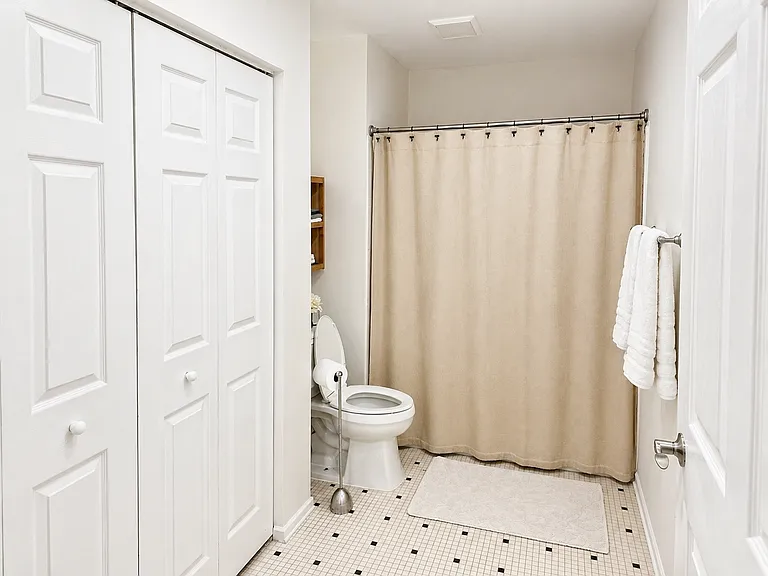 Guest bathroom. Laundry behind doors.