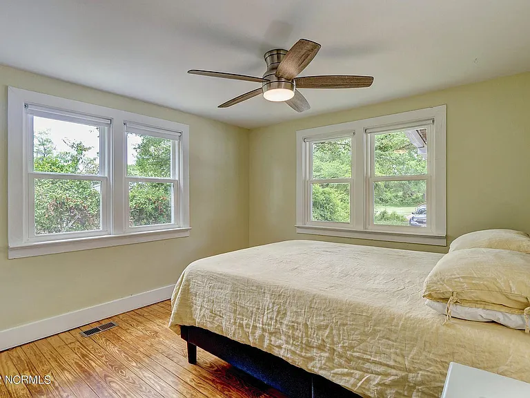 Bedroom 2 with wood floors and remote controlled ceiling fan.