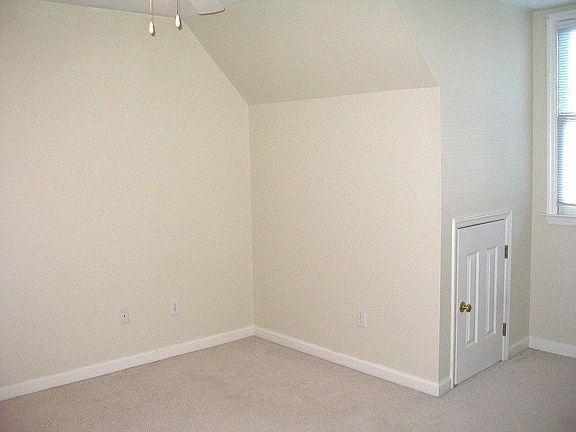 1 of 2 upstairs bedrooms. Note extra storage near window.