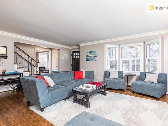 Formal Living Room with hardwood floors, plantation shutters and cozy fireplace.