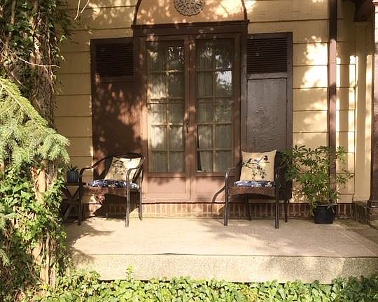 Private French doors open to front porch/sitting area