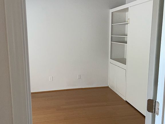 Guest bedroom or office with murphy bed and built in shelves
