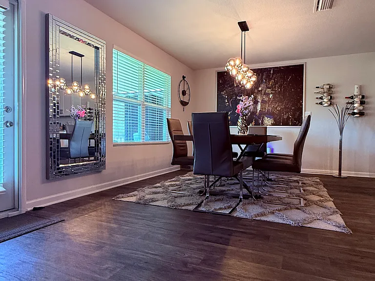 Modern chandelier mounted in the dining room ceiling.
