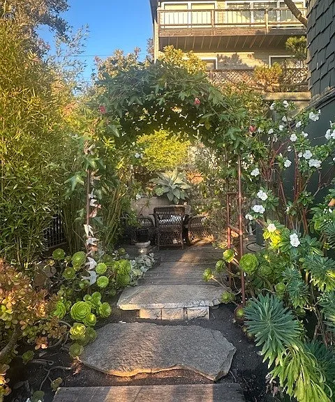 Back yard seating area, garden and flowering arbor