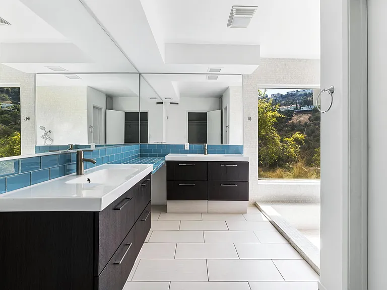Master Bath - large with 10 feet of mirrors, double sink, large vanity area, drawer cabinets, porcelain floors, roman tub with shower, enclosed toilet, walk in closet.