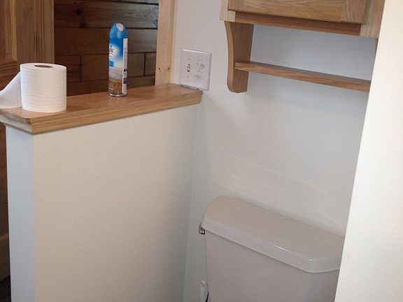 second door and toilet with 1/2 wall