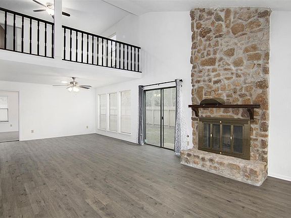 The living area is massive. Fireplace, patio doors, and new floors and paint will welcome all to your new home.