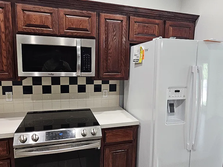 Kitchen appliance view with new refrigerator and fairly new appliances ~ 2 years old