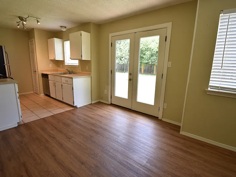 Double doors to the backyard off the dinning room that sits between the living room and the kitchen