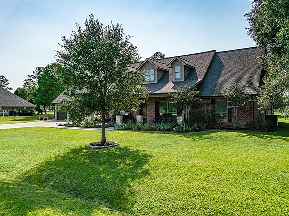Mature trees and lush landscaping with pretty foliage adorns the property. A sprinkler system gets the assist for keeping the lawn looking great!