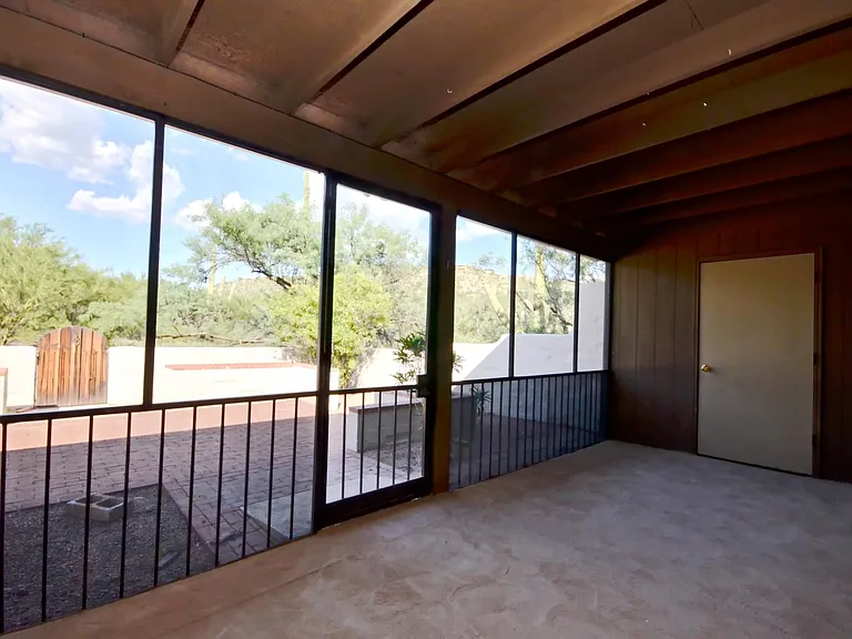 Screened in Arizona room with view to private back patio and open green space on two sides.