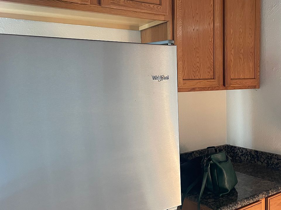 Opposite wall kitchen cabinets and fridge