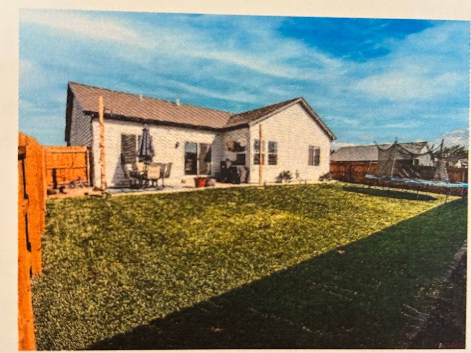 The private back yard is in the process of having trees planted, and has a sprinkler system.