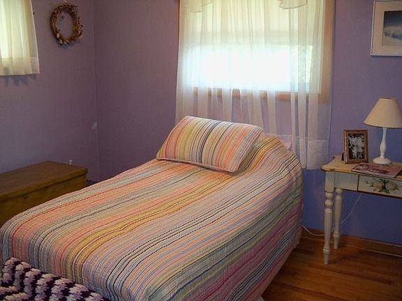second bedroom shows off the beautiful hard wood floors 