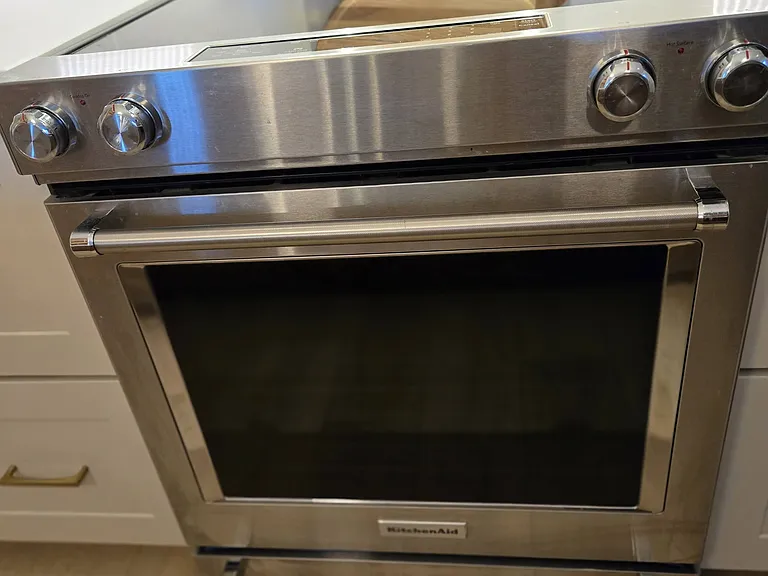 New stainless steel KitchenAid glass-top 5-burner stove and self-cleaning convection oven with custom overhead vent