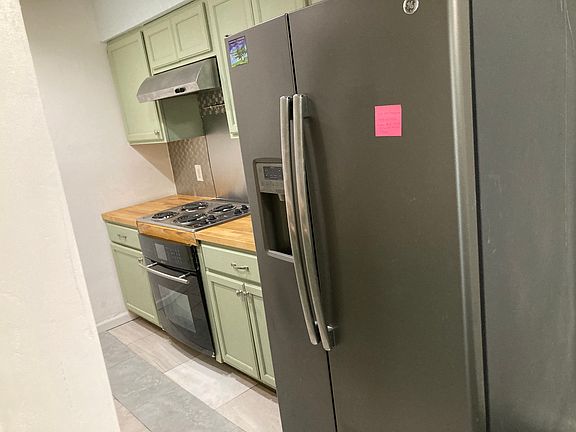 Kitchen with fridge, stove/oven, microwave and faucet