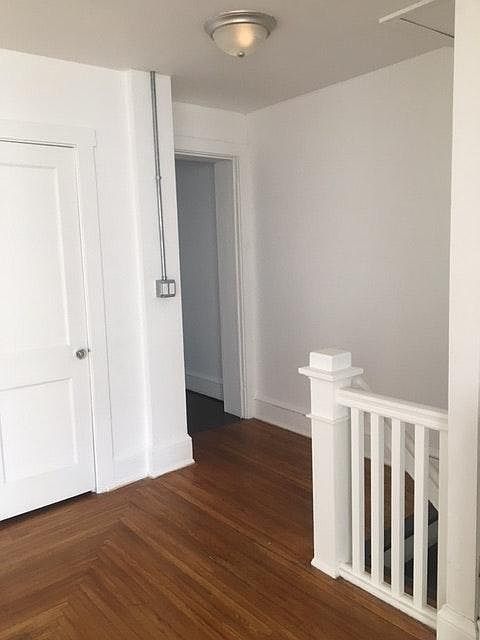 Foyer area with a closet and a security light.