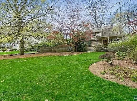 Large front yard. Privacy fence is to the left of the house