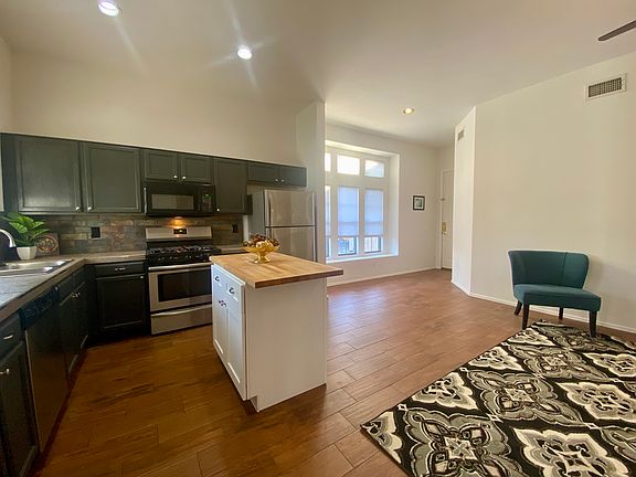 Sharp black motif kitchen with butcher block island
