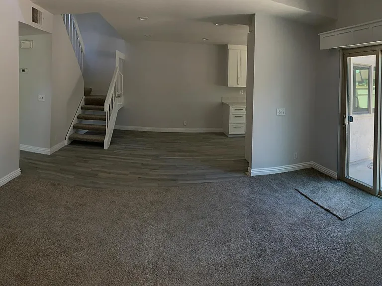 View of living room, dining room and stairs showing access to master bedroom and second bedroom.