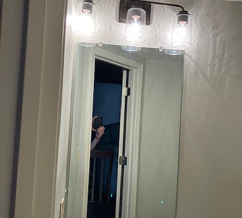 mirror and lighting in half bath upstairs