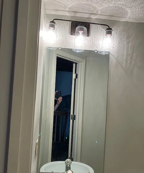 mirror and lighting in half bath upstairs