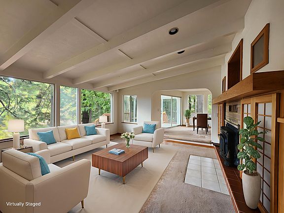 The living room has large picture windows overlooking the bay.