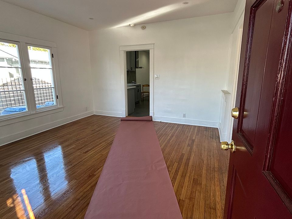 Entrance from the front door into the living room. Oversized windows for plenty of light on two sides of the room.