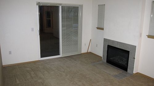 Den with fireplace and balcony