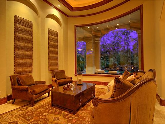Formal living room with unique ceiling, butted glass windows and