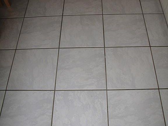 12x12 neutral tile throughout entire liv