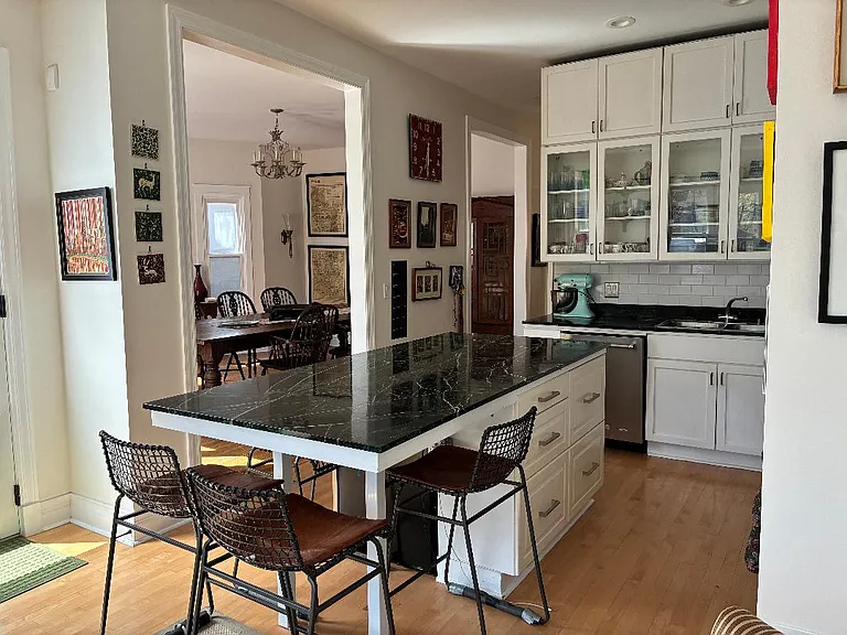 view from family room into kitchen with a peak into DR
