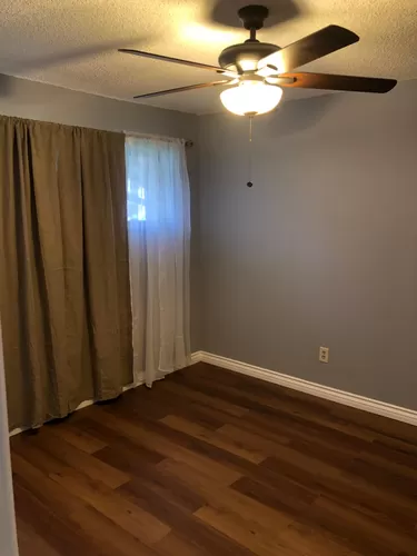 Bedroom#1 has a ceiling fan and new drapery. - 121 Park St #A