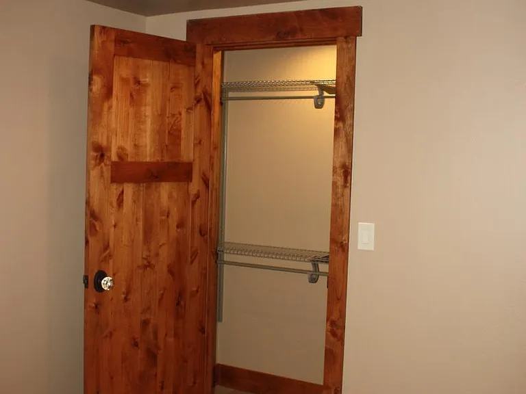 Rustic stained hardwood doors and trim throughout. Closets rods are adjustable. Tile on floor.