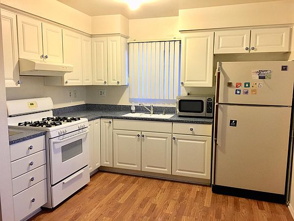 Clean white cabinetry in Kitchen.  Fridge included
